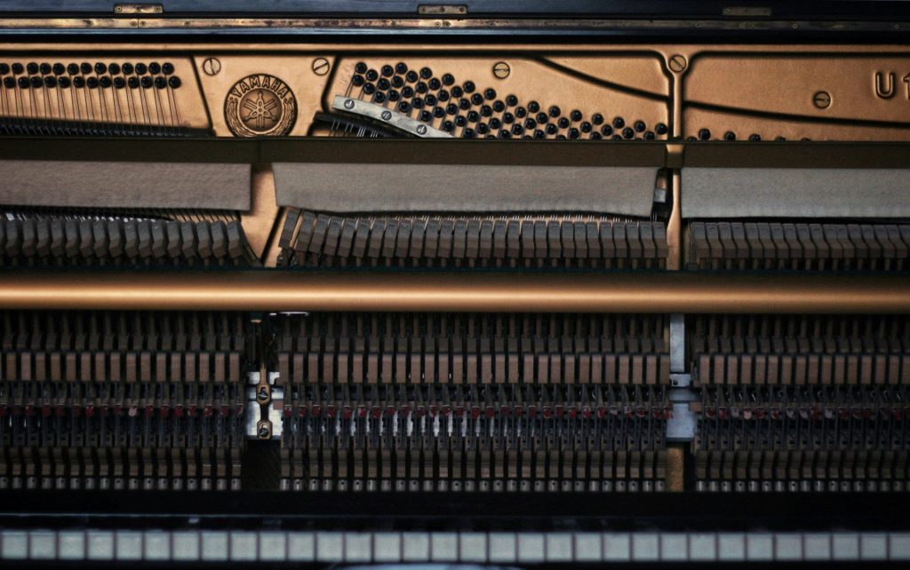 a close up of a piano with the keys missing