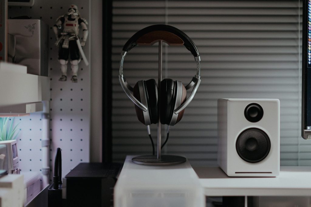 a desk with a computer and speakers on it